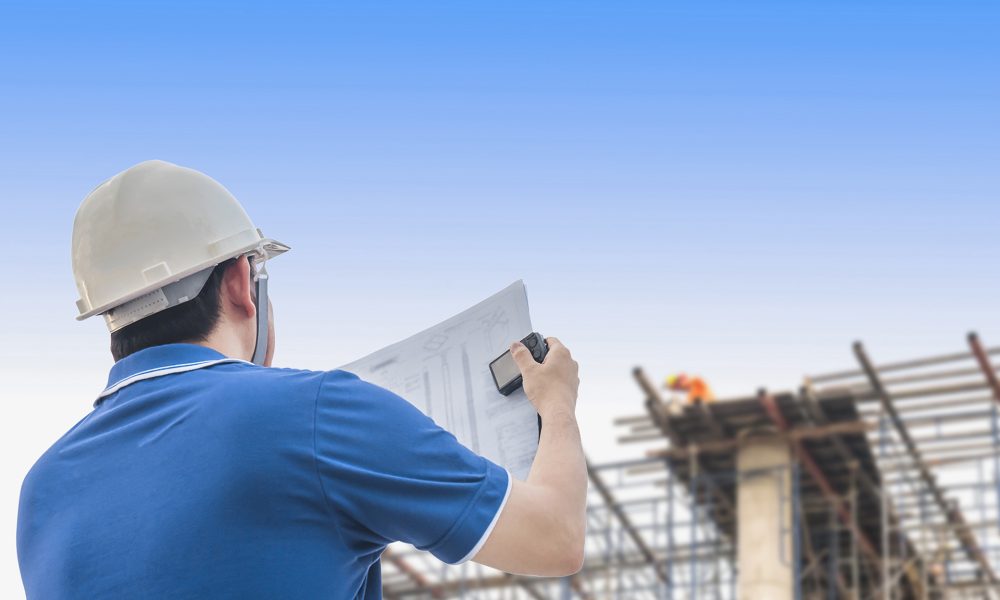 Engineer is inspecting his work in building construction site